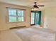 Bright living room featuring a ceiling fan, large window with natural light, and a green front door at 613 Catawba St, Chester, SC 29706