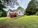 Backyard featuring a deck, lush grass and surrounding trees at 613 Stacy Ridge Rd, Gastonia, NC 28052