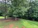 Backyard featuring mature trees and lush grass at 613 Stacy Ridge Rd, Gastonia, NC 28052