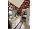 Bright bathroom featuring floral wallpaper, a double vanity, and access to the bedroom at 613 Stacy Ridge Rd, Gastonia, NC 28052