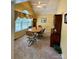 Dining room features tan carpet, yellow walls, a ceiling fan, and large window at 613 Stacy Ridge Rd, Gastonia, NC 28052