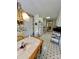 Eat in kitchen featuring tiled table and floors, wallpaper, and white cabinets at 613 Stacy Ridge Rd, Gastonia, NC 28052