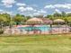 Community pool area with lounge chairs, umbrellas, and a clubhouse at 739 Elders Story Rd, Fort Mill, SC 29708