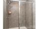 Modern shower with glass door and gray tiling, offering a sleek design at 739 Elders Story Rd, Fort Mill, SC 29708