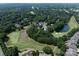 Aerial view of community featuring lush green golf course, mature trees, and serene ponds enhancing the landscape at 7732 Waverly Walk Ave, Charlotte, NC 28277