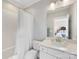 Clean and simple white bathroom with a shower and a mirrored vanity at 7732 Waverly Walk Ave, Charlotte, NC 28277
