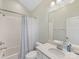 Bright bathroom with white tiling and a modern vanity with quartz countertops at 7732 Waverly Walk Ave, Charlotte, NC 28277