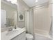 Well-lit bathroom with a shower-tub combo and a white granite countertop at 7732 Waverly Walk Ave, Charlotte, NC 28277