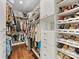 Walk-in closet with custom shelves, drawers, and ample storage for clothes and shoes at 7732 Waverly Walk Ave, Charlotte, NC 28277