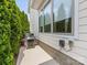 Exterior view features a grill, garden bed and a large window reflecting the lush greenery surrounding the property at 7732 Waverly Walk Ave, Charlotte, NC 28277