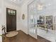 Foyer leading to a bright office space featuring hardwood floors and an elegant doorway at 7732 Waverly Walk Ave, Charlotte, NC 28277
