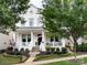 Charming two-story home with a classic white porch, manicured lawn, and picturesque landscaping at 7732 Waverly Walk Ave, Charlotte, NC 28277