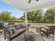 Relaxing front porch with cozy seating and a view of the lush green landscape at 7732 Waverly Walk Ave, Charlotte, NC 28277