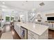 Open concept gourmet kitchen with oversized island with sink and dining area, and access to living spaces at 7732 Waverly Walk Ave, Charlotte, NC 28277