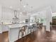 White kitchen featuring an island, stainless steel appliances and fixtures, and recessed and pendant lighting at 7732 Waverly Walk Ave, Charlotte, NC 28277