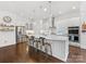Eat-in kitchen with stainless appliances, white subway tile backsplash, marble counters, and pendant lighting at 7732 Waverly Walk Ave, Charlotte, NC 28277