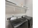 This is a laundry room with front loading washer and dryer and built in shelving at 7732 Waverly Walk Ave, Charlotte, NC 28277