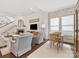 Cozy living room showcases a fireplace, TV, staircase and comfortable seating for relaxing and entertaining at 7732 Waverly Walk Ave, Charlotte, NC 28277