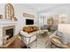 Comfortable living room with decorative fireplace, television, and a variety of seating options at 7732 Waverly Walk Ave, Charlotte, NC 28277