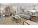 Open concept living room with hardwood floors, decorative fireplace, comfortable furniture, and access to kitchen at 7732 Waverly Walk Ave, Charlotte, NC 28277