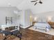 Spacious bedroom with wood floors, a desk, and exercise equipment at 7732 Waverly Walk Ave, Charlotte, NC 28277