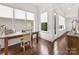 Home office with natural light, hardwood floors and a glass desk at 7732 Waverly Walk Ave, Charlotte, NC 28277