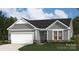 Charming single-Gathering home with gray siding, stone accents, and a pristine two-car garage at 908 Exeter Dr, Sherrills Ford, NC 28673