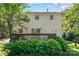 Charming home exterior showcasing a spacious backyard and a deck with flourishing greenery at 9701 Kent Village Dr, Charlotte, NC 28269