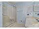 Clean bathroom featuring shower, vanity with sink, and storage cabinet at 9701 Kent Village Dr, Charlotte, NC 28269