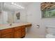 Functional bathroom featuring a dual sink vanity, toilet, and shower-tub combination at 9701 Kent Village Dr, Charlotte, NC 28269