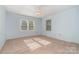 Light-filled bedroom with carpet, fan, and natural light from two windows at 9701 Kent Village Dr, Charlotte, NC 28269