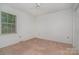 Simple bedroom with carpet, a window providing natural light, and a spacious closet at 9701 Kent Village Dr, Charlotte, NC 28269