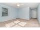 Spacious bedroom featuring carpeted floors, fan, and two windows at 9701 Kent Village Dr, Charlotte, NC 28269