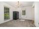 Large bedroom featuring carpeted flooring, natural light, and a large safe at 9701 Kent Village Dr, Charlotte, NC 28269