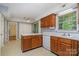 Kitchen with wood cabinets, neutral countertops, and view into other rooms at 9701 Kent Village Dr, Charlotte, NC 28269