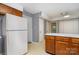 View of the kitchen leading to other rooms and showing white refrigerator and storage at 9701 Kent Village Dr, Charlotte, NC 28269