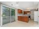 Functional kitchen with wood cabinets, an island, and a sliding glass door to outdoor area at 9701 Kent Village Dr, Charlotte, NC 28269