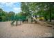 A well-equipped playground for children with slides, climbing structures, and a soft landing surface at 9701 Kent Village Dr, Charlotte, NC 28269
