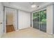 Bright sun room with sliding doors, closet, and views of the backyard at 9701 Kent Village Dr, Charlotte, NC 28269