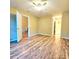 Spacious bedroom with modern vinyl flooring, two entry doorways, and a ceiling fan at 10105 Reindeer Way Ln, Charlotte, NC 28216
