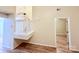 Well-lit hallway with modern floors, white railing stairs, and a glimpse of a bedroom entrance at 10105 Reindeer Way Ln, Charlotte, NC 28216