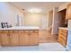 Open concept kitchen with an island, wood cabinets, and new floors at 10105 Reindeer Way Ln, Charlotte, NC 28216
