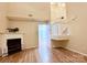 Bright living room featuring a fireplace, wood flooring, and staircase at 10105 Reindeer Way Ln, Charlotte, NC 28216