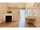 Bright living room featuring a fireplace, wood flooring, and staircase at 10105 Reindeer Way Ln, Charlotte, NC 28216