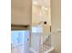 Bright staircase featuring a modern chandelier, white banisters, and wood-like flooring at 10105 Reindeer Way Ln, Charlotte, NC 28216