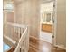 Upstairs landing featuring modern chandelier and an open bathroom entrance at 10105 Reindeer Way Ln, Charlotte, NC 28216