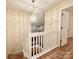 Upstairs landing featuring a modern chandelier and an open bedroom entrance at 10105 Reindeer Way Ln, Charlotte, NC 28216