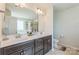 Bathroom featuring double sinks, vanity with drawers, and a large mirror with decorative lighting at 1012 Leland Dr, Wesley Chapel, NC 28104