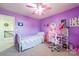 Bedroom boasts lilac walls, a ceiling fan, and a desk, creating a fun atmosphere at 1012 Leland Dr, Wesley Chapel, NC 28104