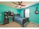 Bright bedroom features blue walls, a ceiling fan, a desk and a full size bed at 1012 Leland Dr, Wesley Chapel, NC 28104
